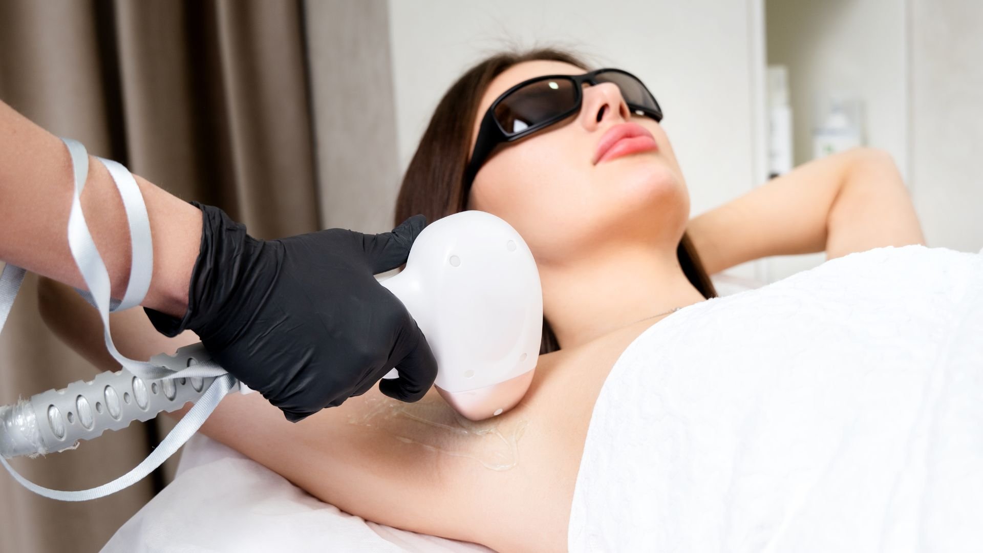 Laser hair removal treatment with protective glasses in medical spa